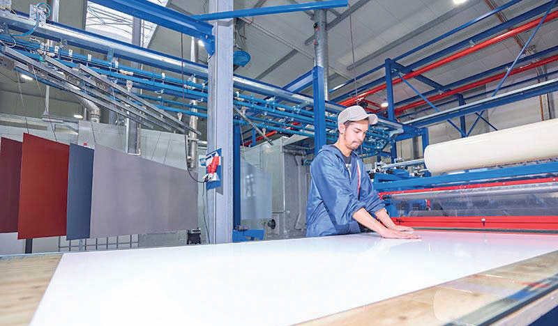 A worker in one of the coating bays.